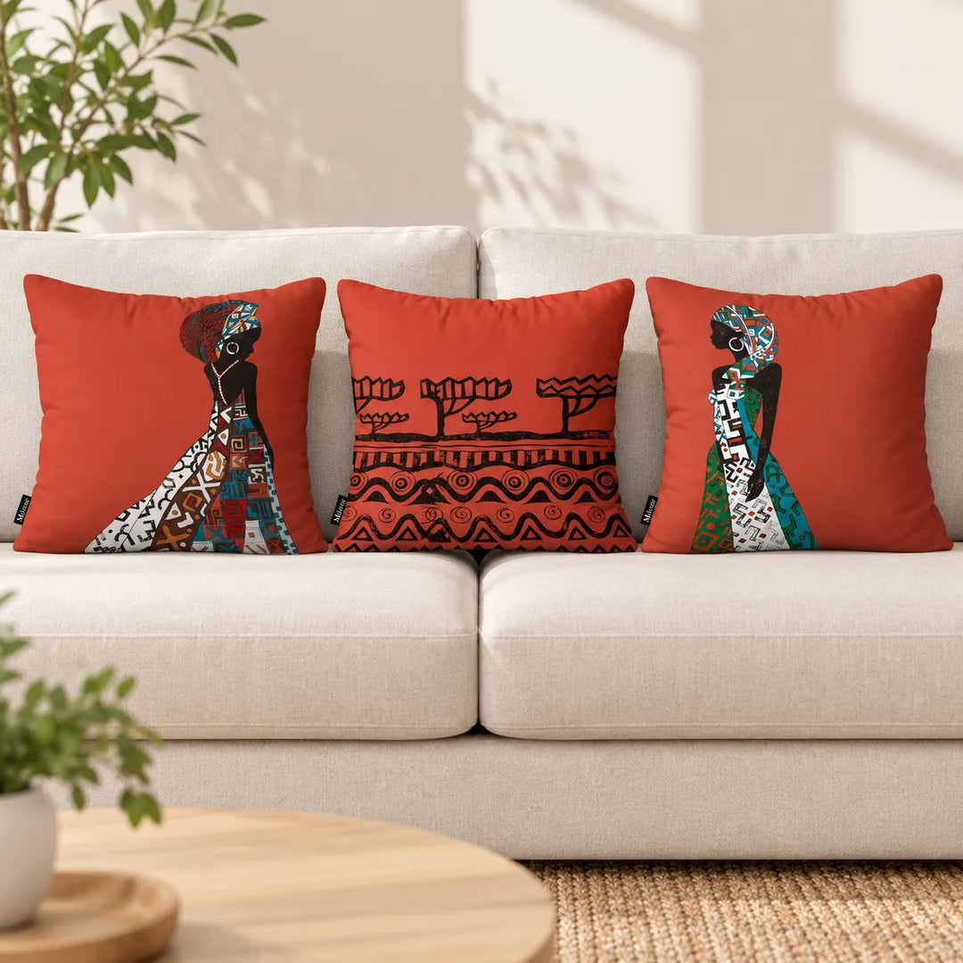Three Valina terracotta cushion covers with two distinct portrait prints and a black tree-and-border design on a neutral sofa