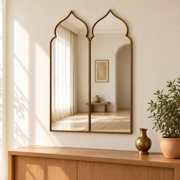Moorish double arch mirror above an oak console with brass vase and greenery. Digitally styled visualization.