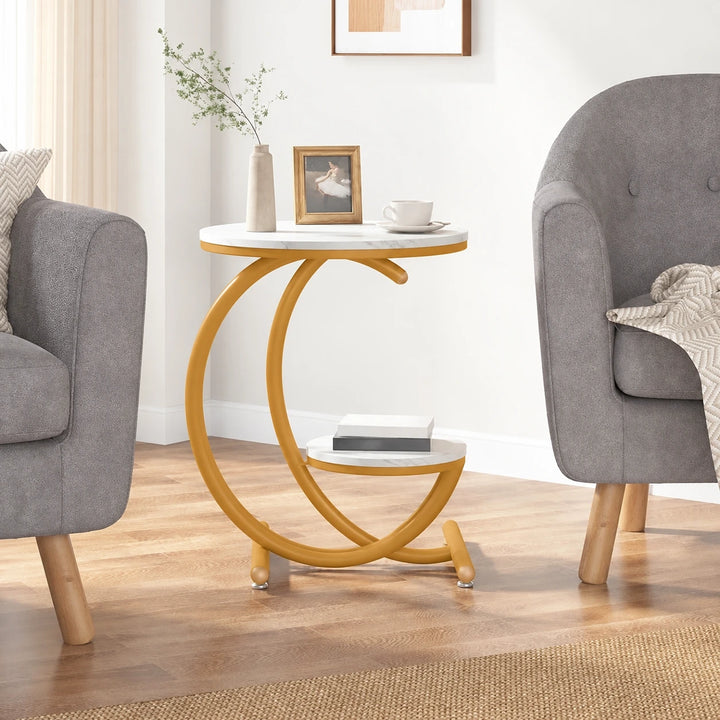 Alenz two-tier white marble-effect side table with warm ochre powder-coated curved frame and round tube feet between armchairs