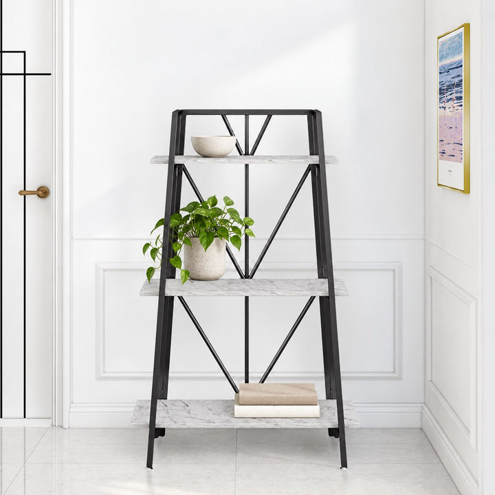 Carnation Medium three-tier marble-effect ladder bookcase with black frame, books and green plant against a white wall