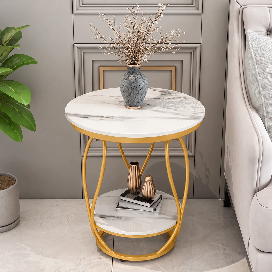 Gilded two-tier round white marble-effect side table with warm ochre powder-coated frame beside sofa