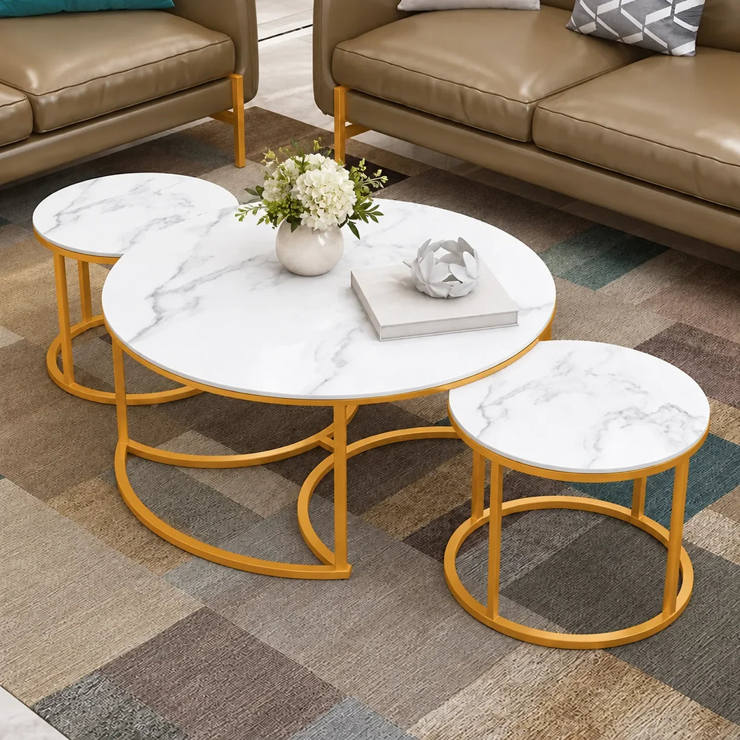 Maywood Courtyard set of three white marble MDF coffee tables with Akil Gold powder-coated bases in a living room