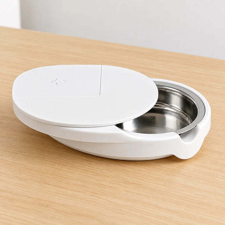 White ashtray with lid slid open showing stainless steel bowl on desk