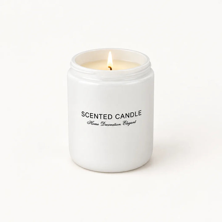 Lit scented candle in white glass jar, front view on cream background