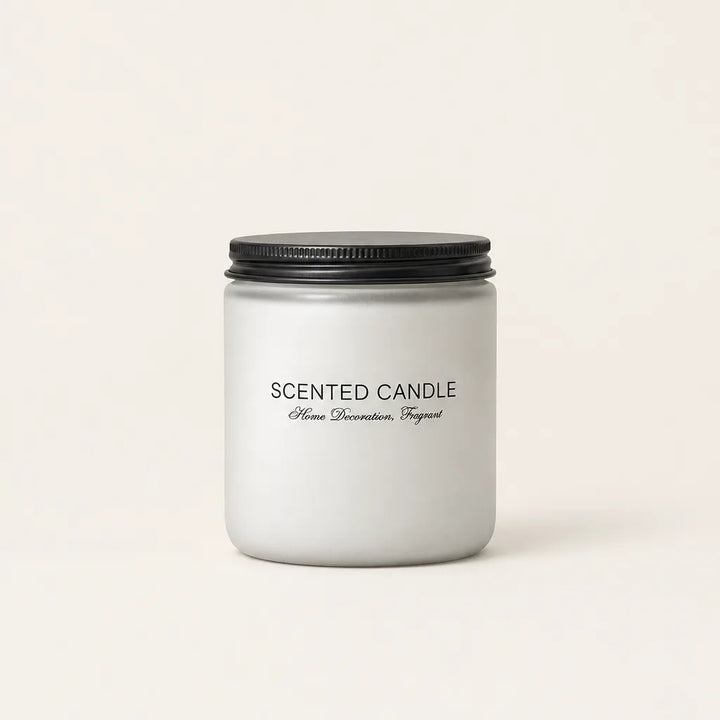 Scented candle in frosted grey glass jar with black lid on white background