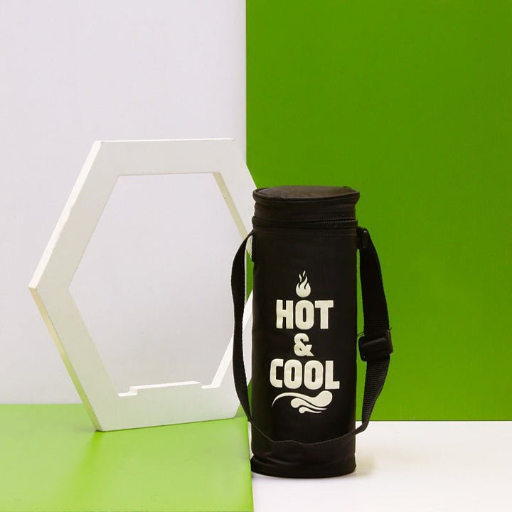 Small black thermos storage bag standing upright in front of green wall