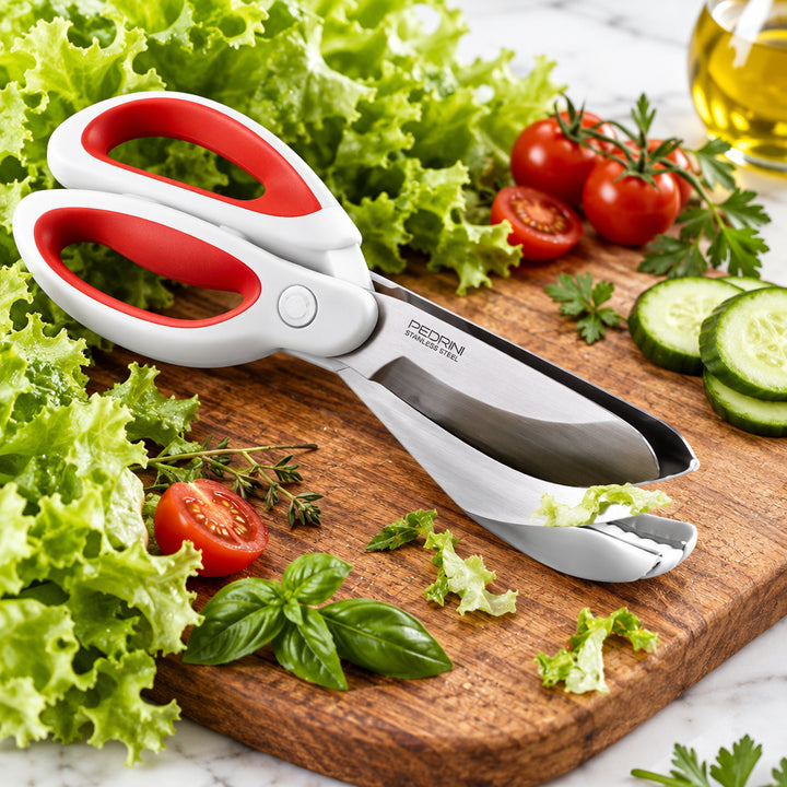 Salad scissors cutting lettuce leaves over a wooden bowl of green salad