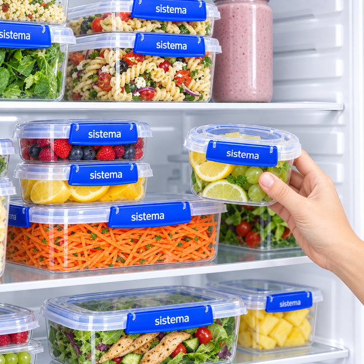Hand taking rectangular clip lock food box from fridge shelf of stacked containers