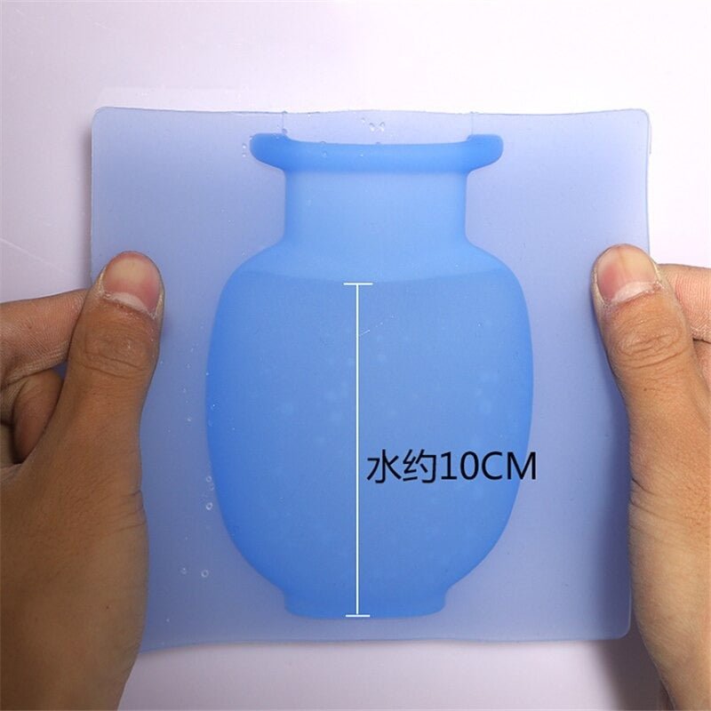 Hands holding blue silicone vase wall sticker showing 10 cm width